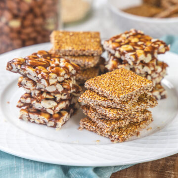 4 stacks of til chikki and peanut chikki in a plate