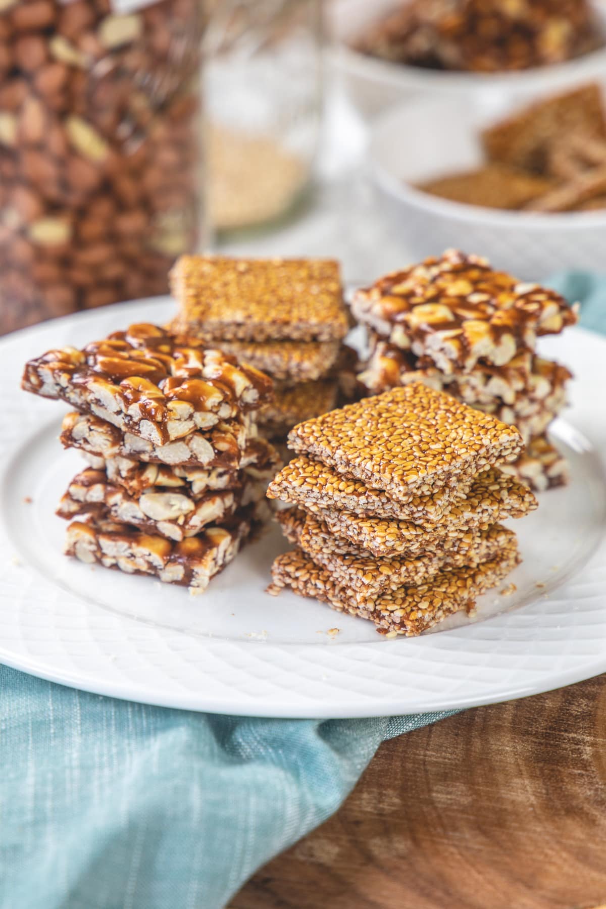 4 stacks of til chikki and peanut chikki in a plate