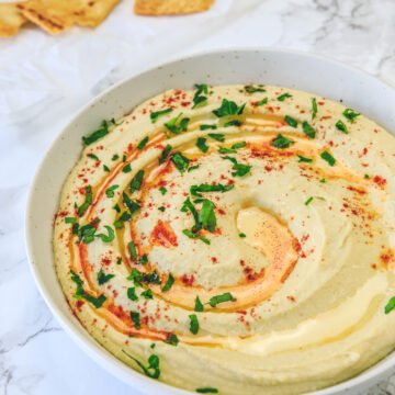 Instant pot hummus served with a drizzle of olive oil and sprinkle of paprika.