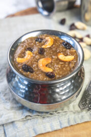 Sakkarai pongal garnish with fried cashews, raisins with napkin underneath.