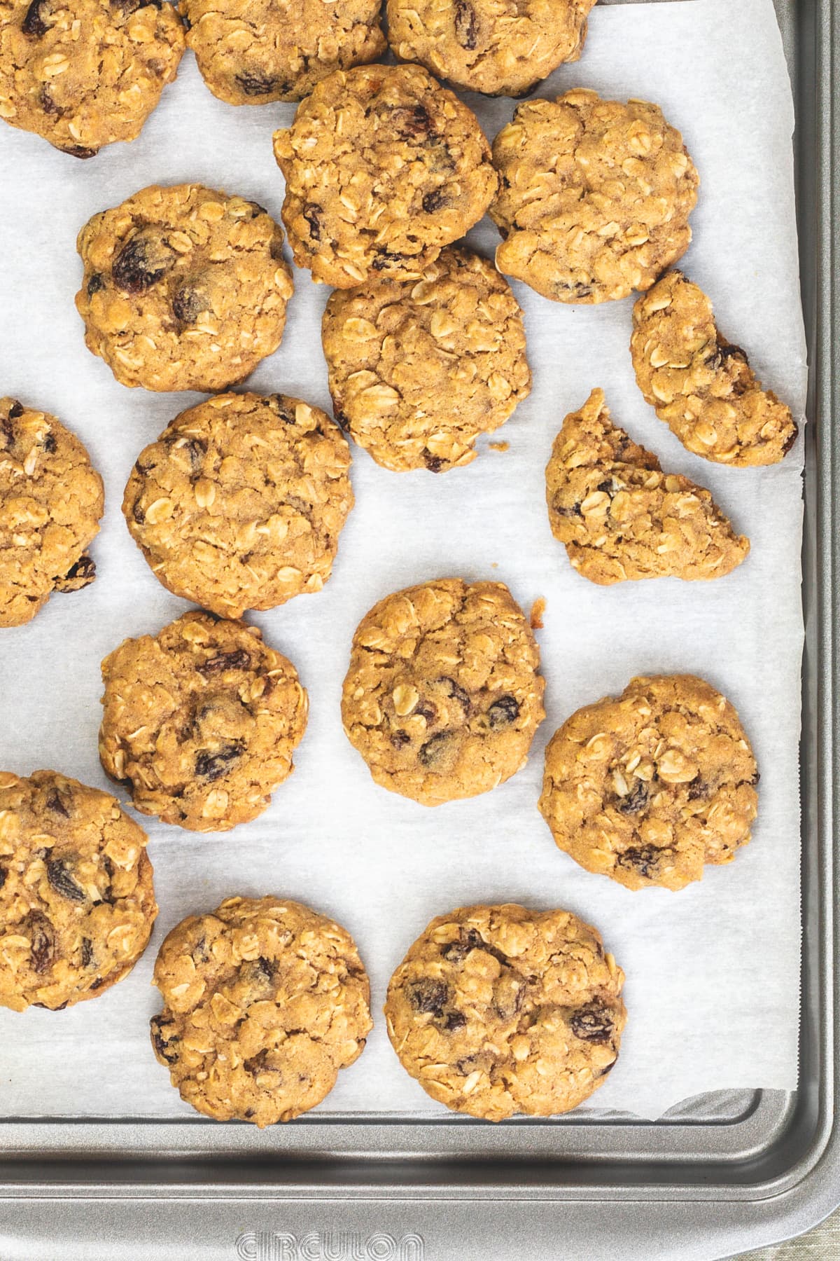 eggless oatmeal cookies on a parchment paper lined cookie sheet.