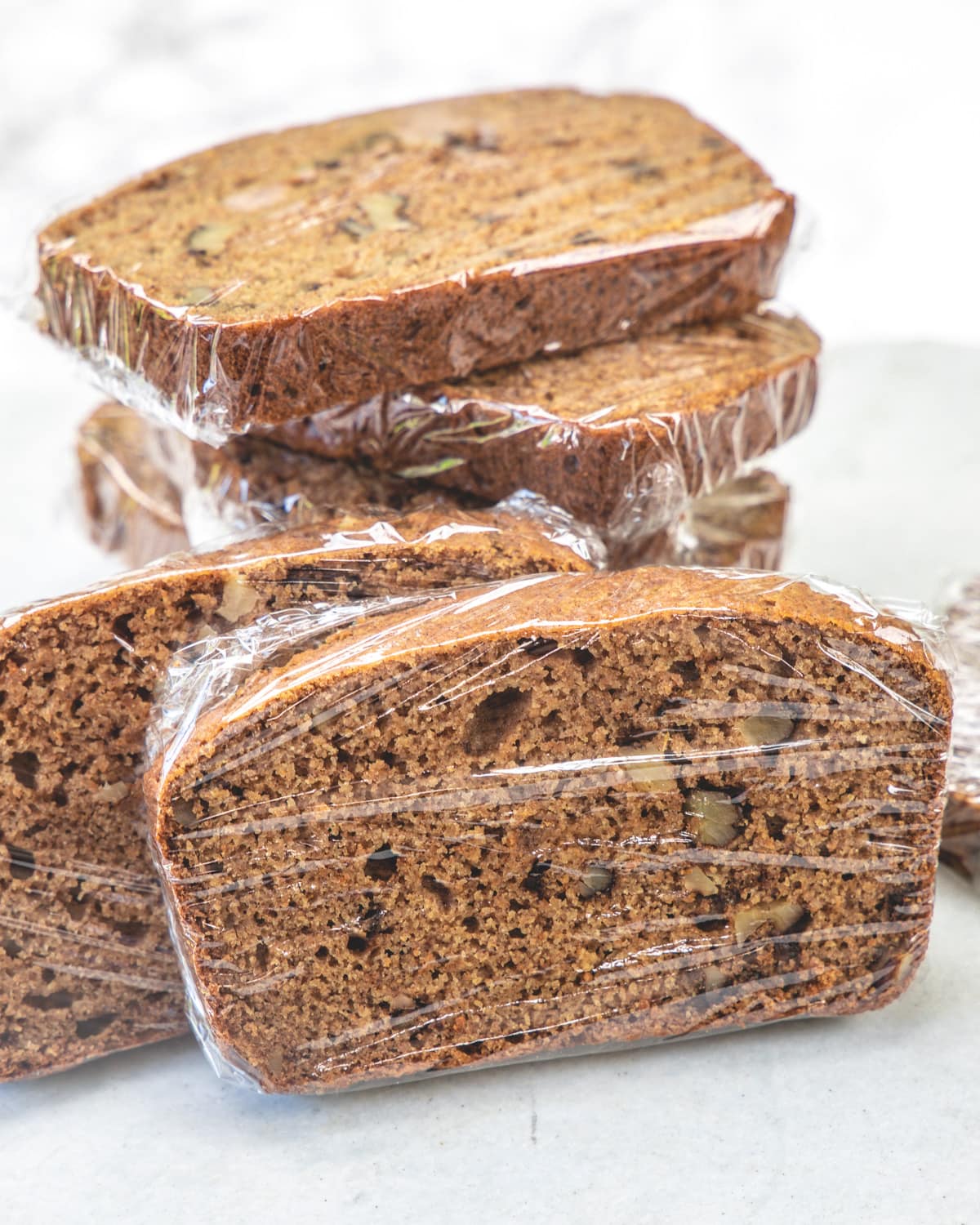 Applesauce bread wrapped individually in plastic wrap.