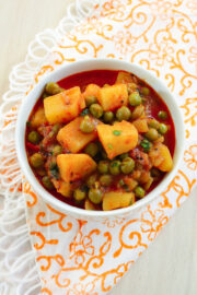 aloo matar served in a bowl with napkin underneath.