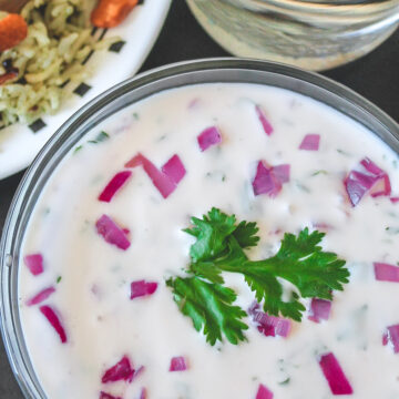 Onion raita served with rice and a glass of water.