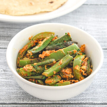 Bhindi capsicum served in a white bowl with roti.