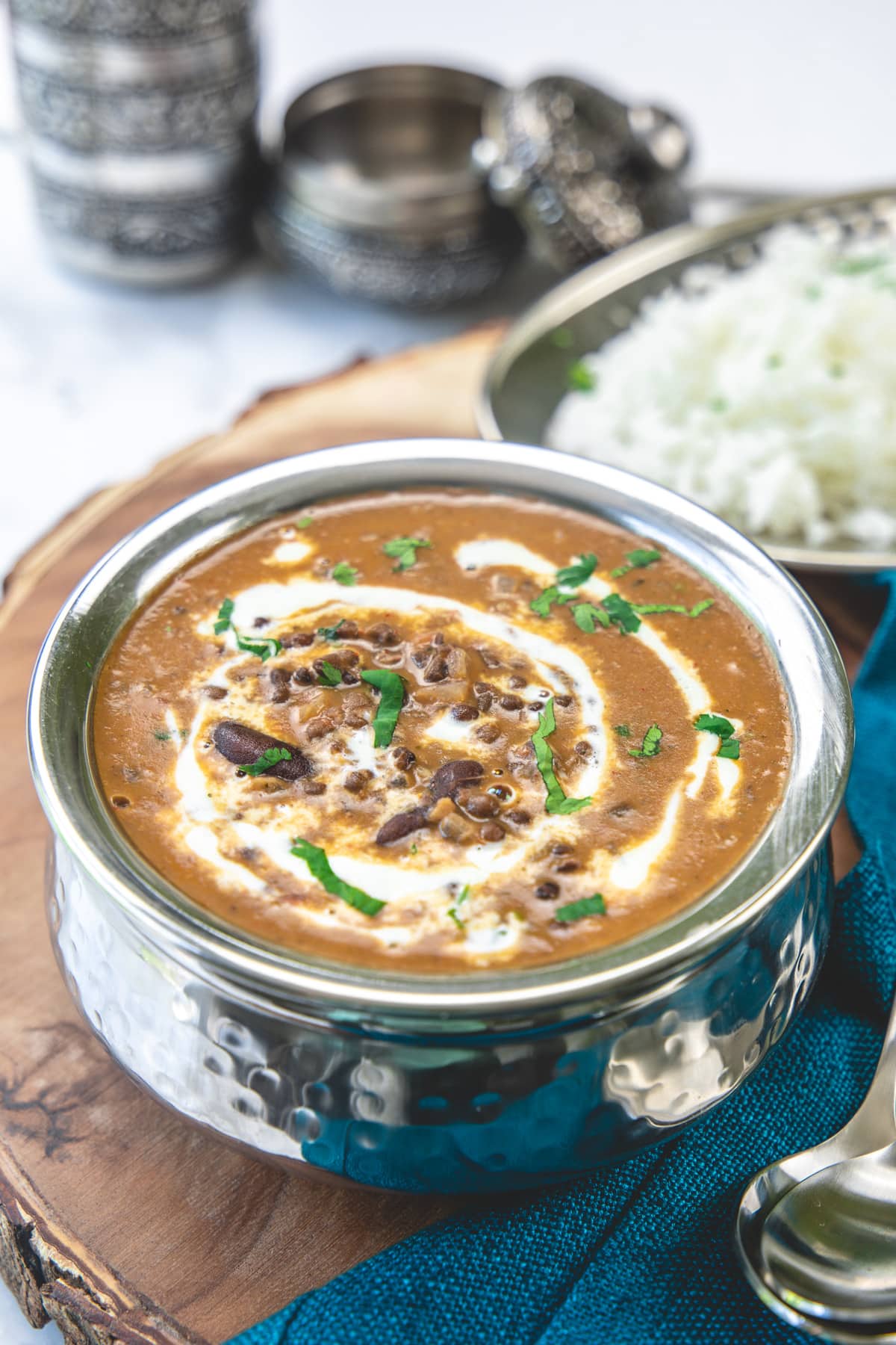 Dal makhani with a drizzle of cream sevred with rice on the side.