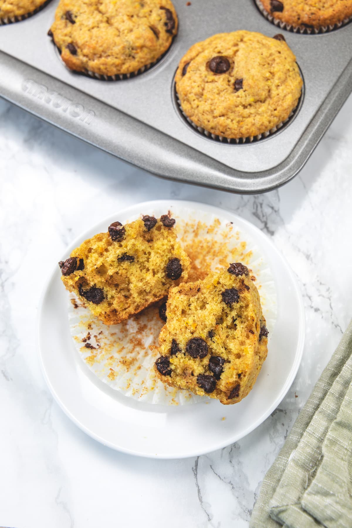 Orange muffins cut open in half to show texture.