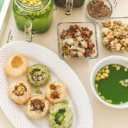 Pani puri served in oval plate with all its elements served on side.