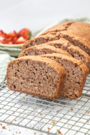 Slices on strawberry bread on a cooling rack.