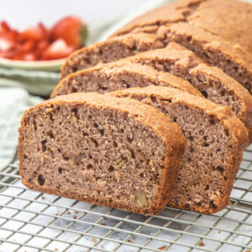 Slices on strawberry bread on a cooling rack.