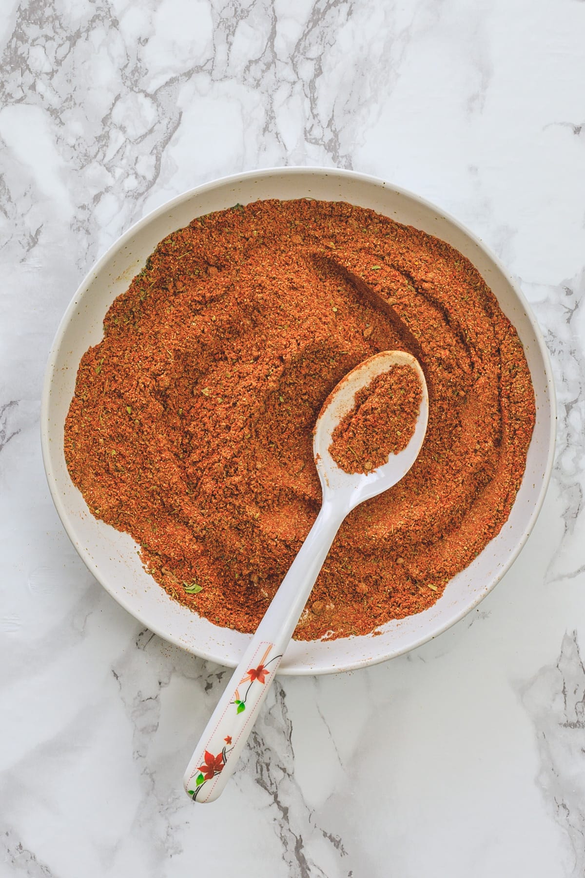 Tikka masala spice mix in a plate with spoon in it.