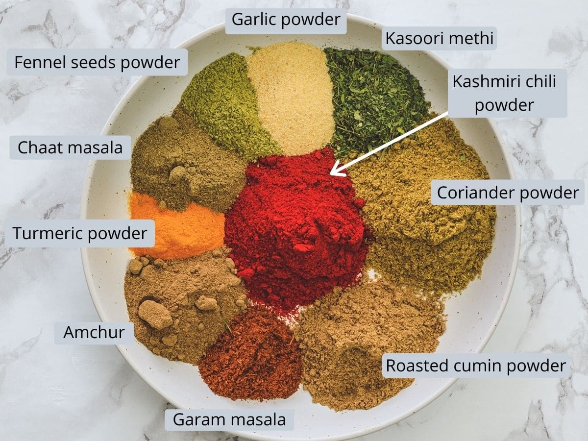 Individual spice powders are in a plate with labels.