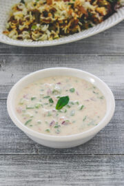 Mix veg raita garnished with mint leaf and served with biryani.