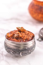Andhra mango pickle in a steel serving bowl jar.