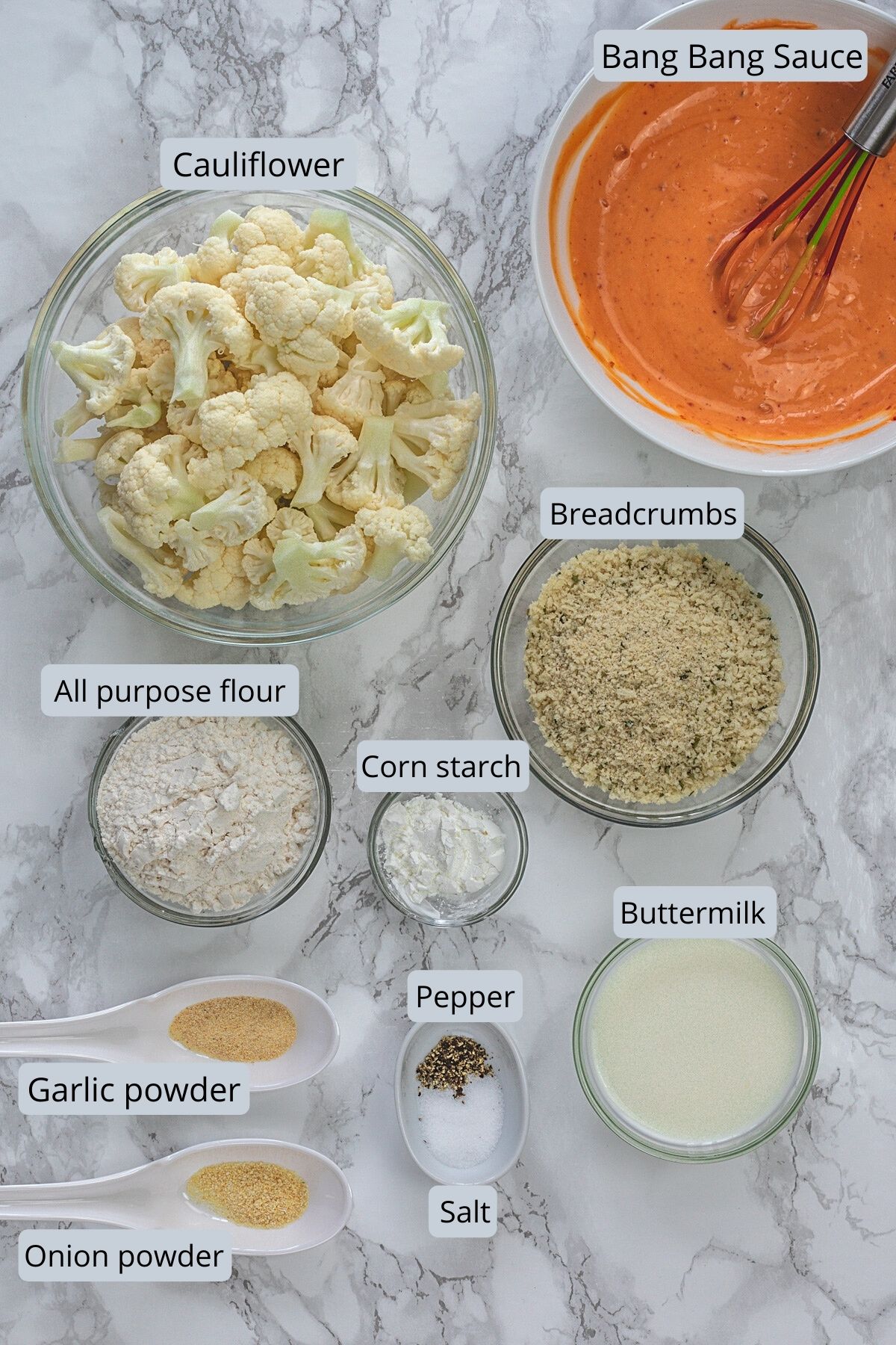 Bang bang cauliflower ingredients with labels on marble surface.