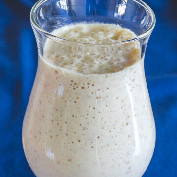 Kaju anjeer milkshake served in a glass.