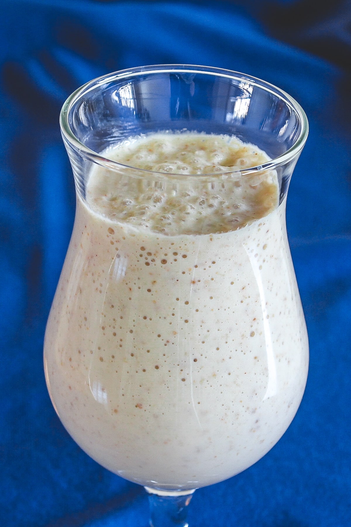 Kaju anjeer milkshake served in a glass.