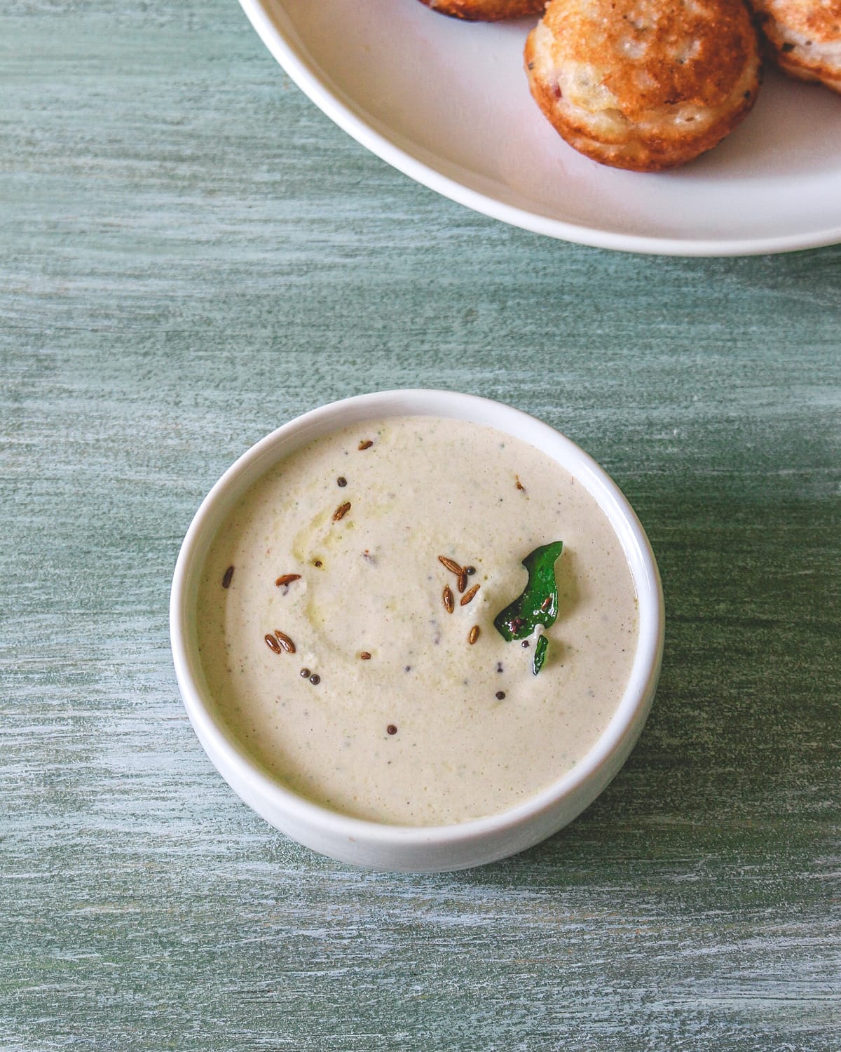 Peanut chutney served in a white bowl.