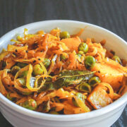 Cabbage sabzi served in a white bowl.