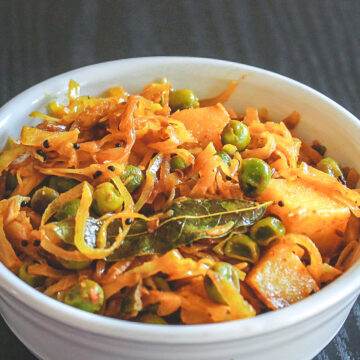 Cabbage sabzi served in a white bowl.