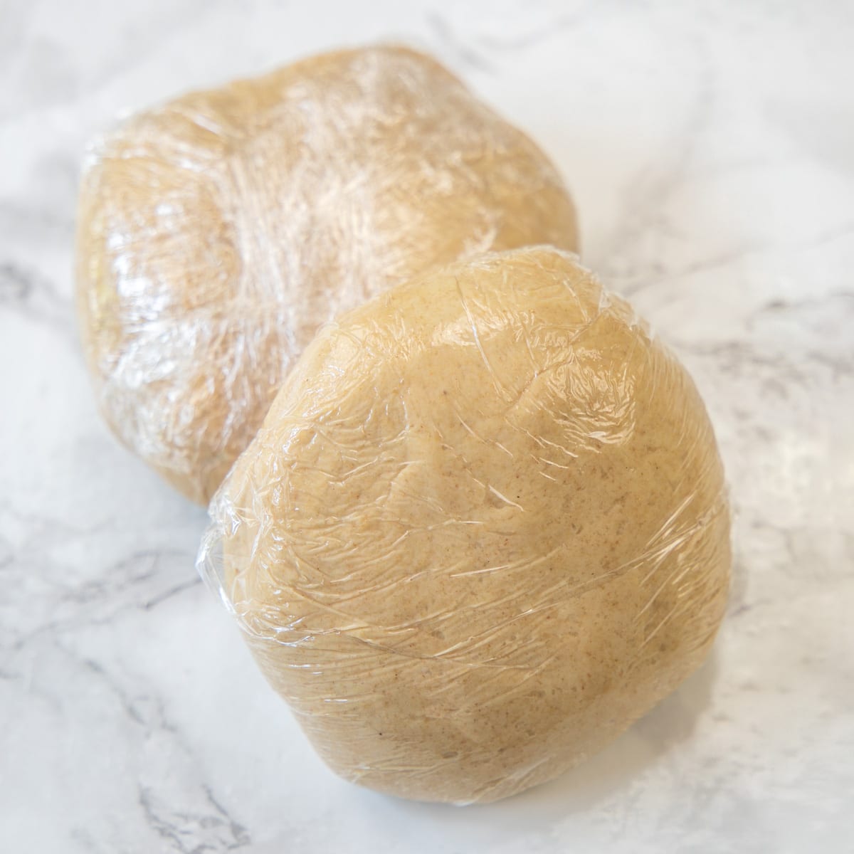 Roti dough wrapped in the plastic wrap.