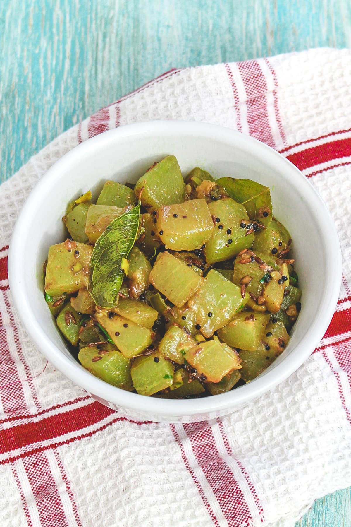 Lauki sabzi in a bowl with napkin underneath.