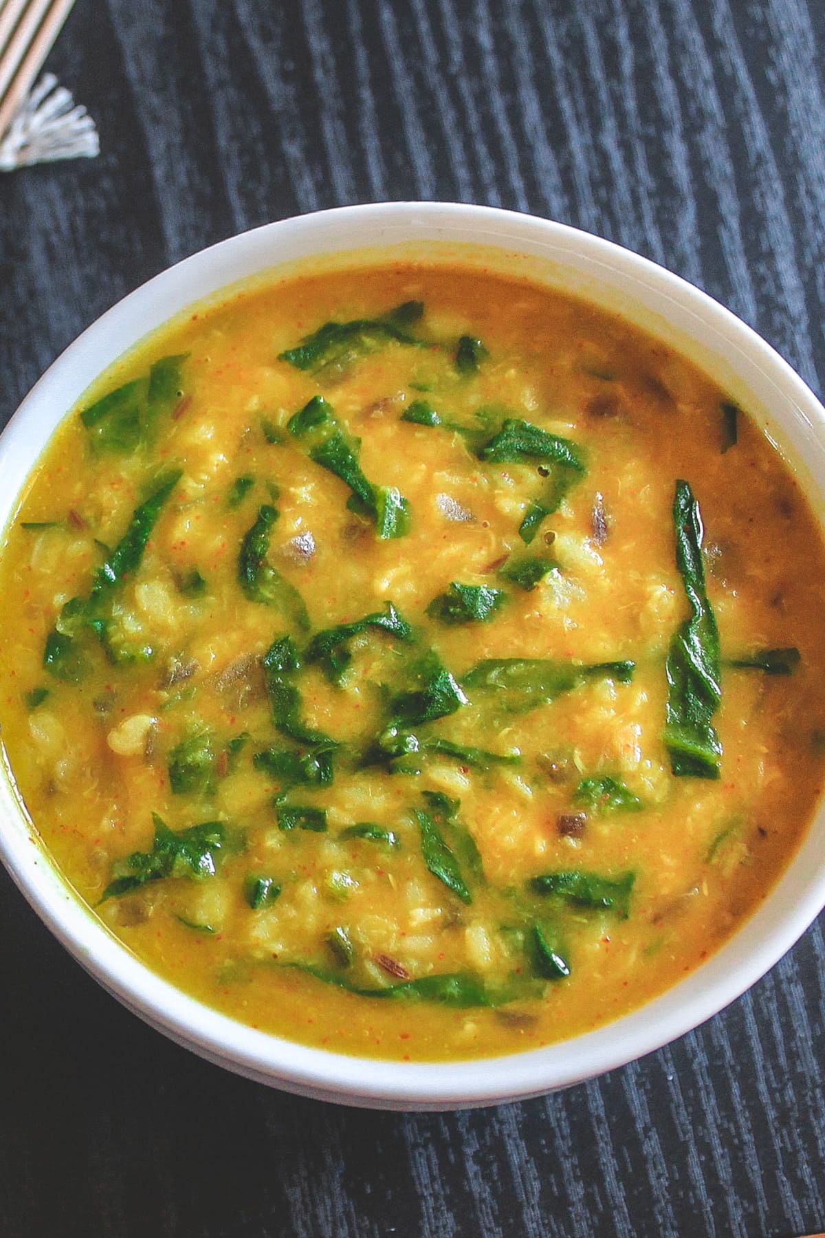 Spinach dal served in a white bowl.