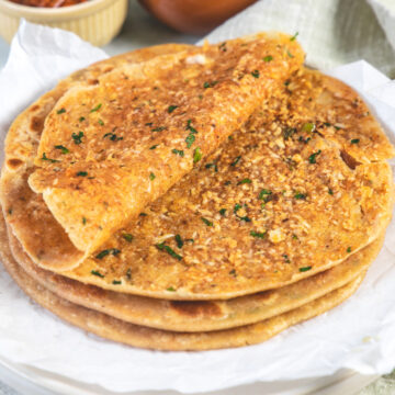 Paneer paratha cut open to show the stuffing.