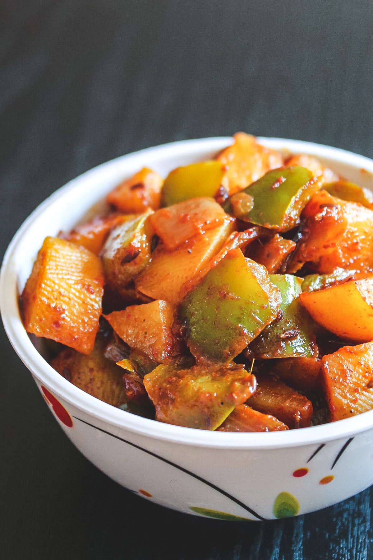 Aloo capsicum served in a bowl.