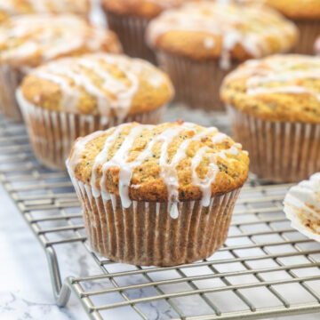 Lemon poppy seed muffins on a cooling rack.