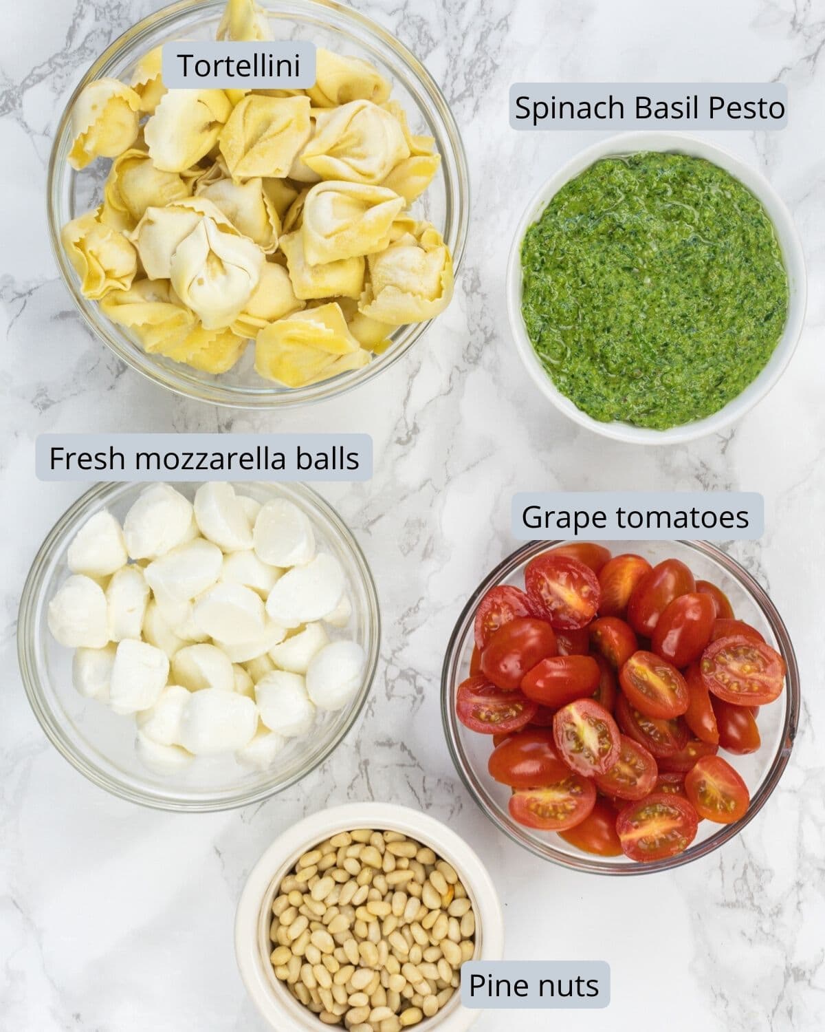 Pesto tortellini salad ingredients with labels