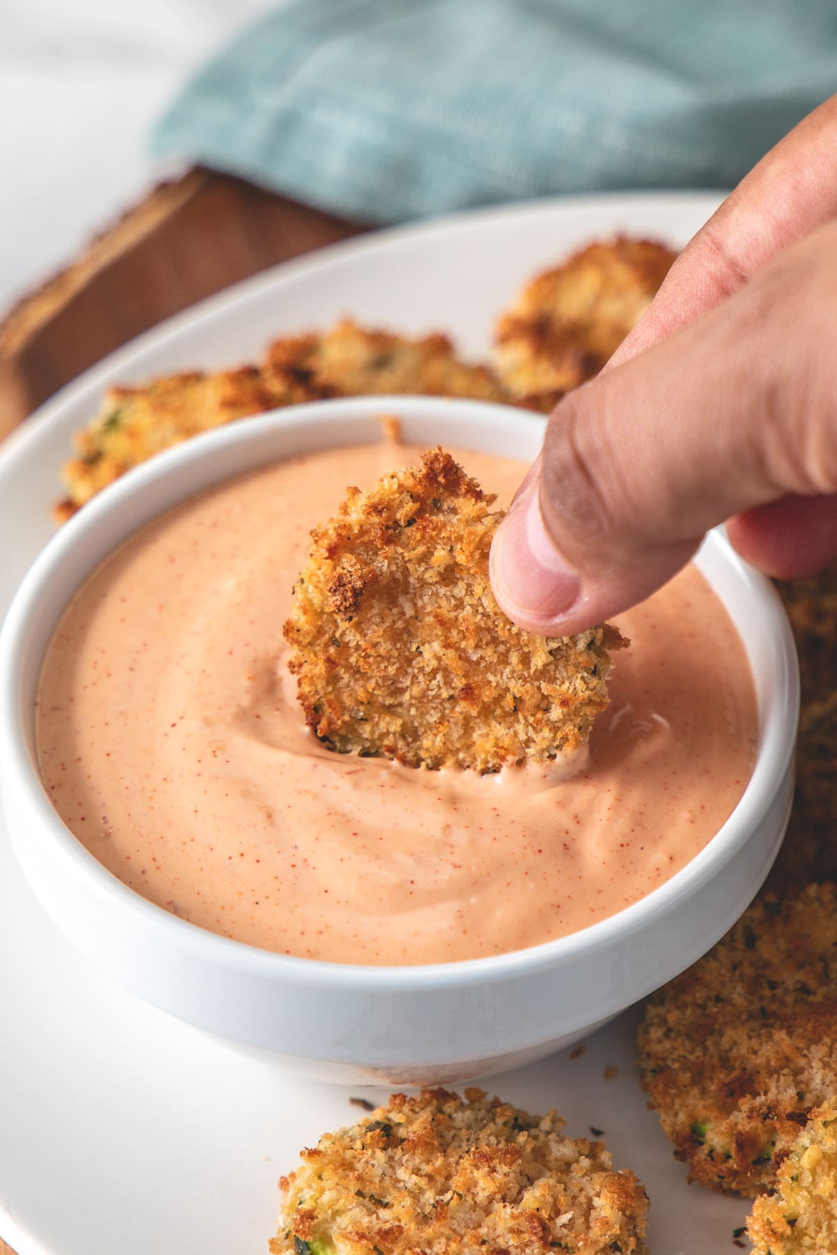 Air fryer zucchini chips dipped into fry sauce.