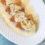 Shahi tukda triangle pieces in a plate with napkin underneath.