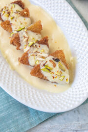 Shahi tukda triangle pieces in a plate with napkin underneath.