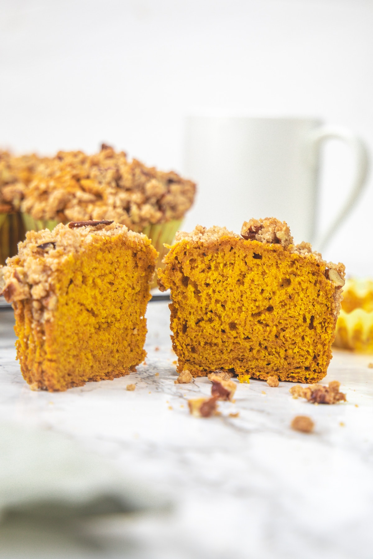 Eggless pumpkin muffin cut into half to show inside texture.