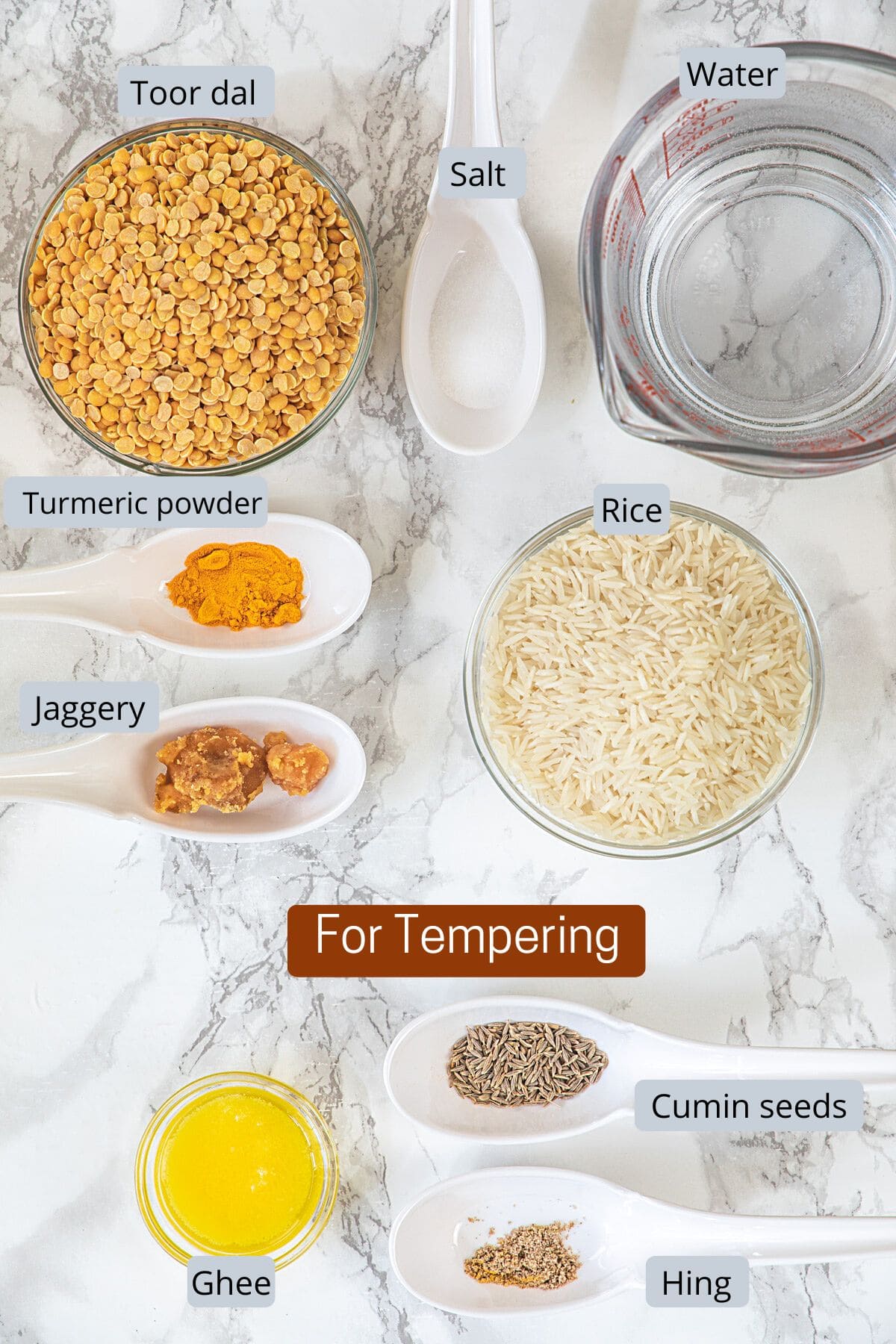 Varan bhaat ingredients in bowls and spoons with label.