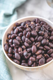 Cooked black beans in a bowl with napkin on the side.