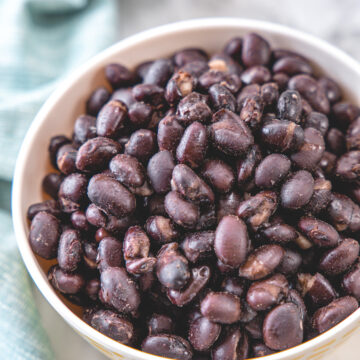 Cooked black beans in a bowl with napkin on the side.