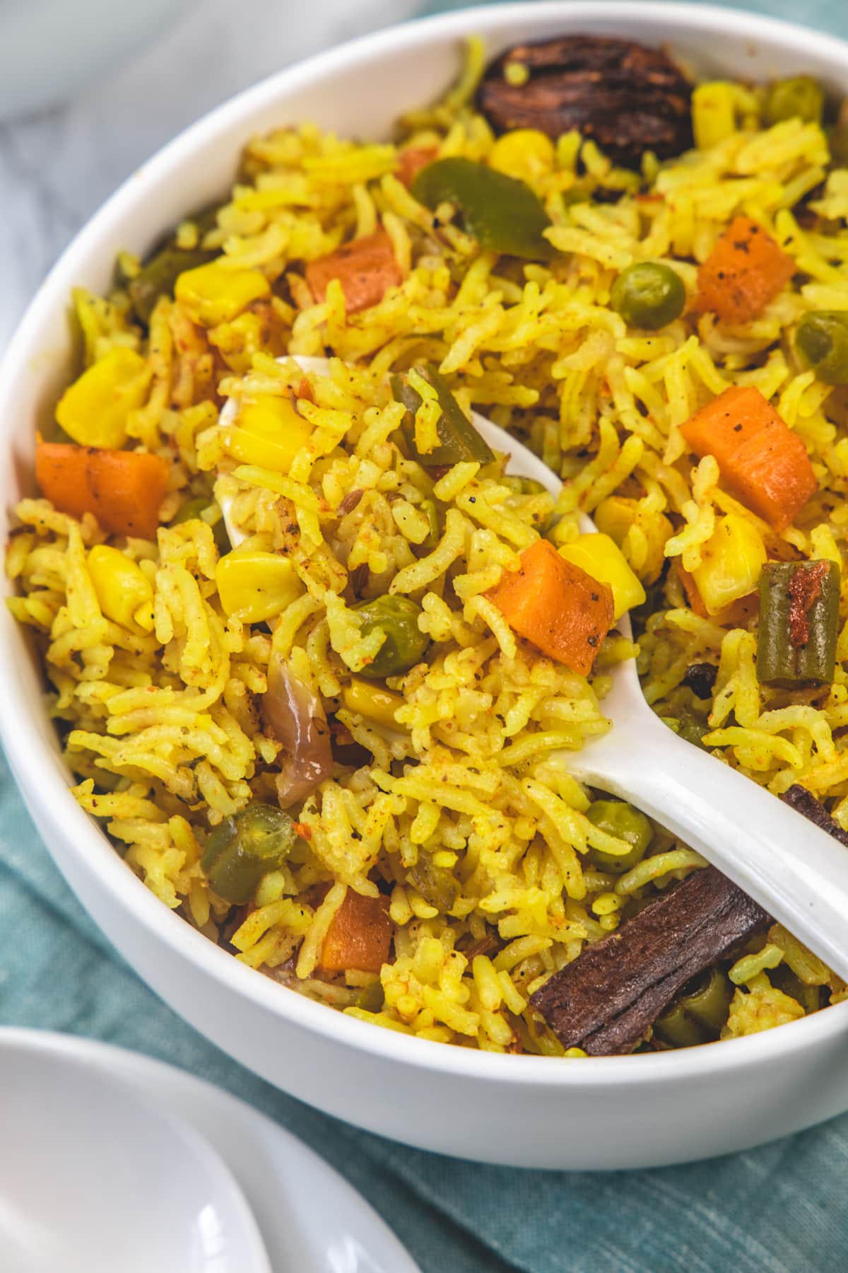 Taking a spoonful of pulao from the bowl.