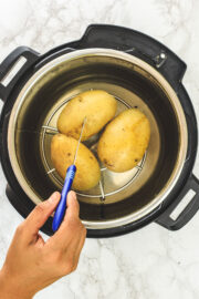 Boiled potatoes in instant pot and inserting a knife into a potato.