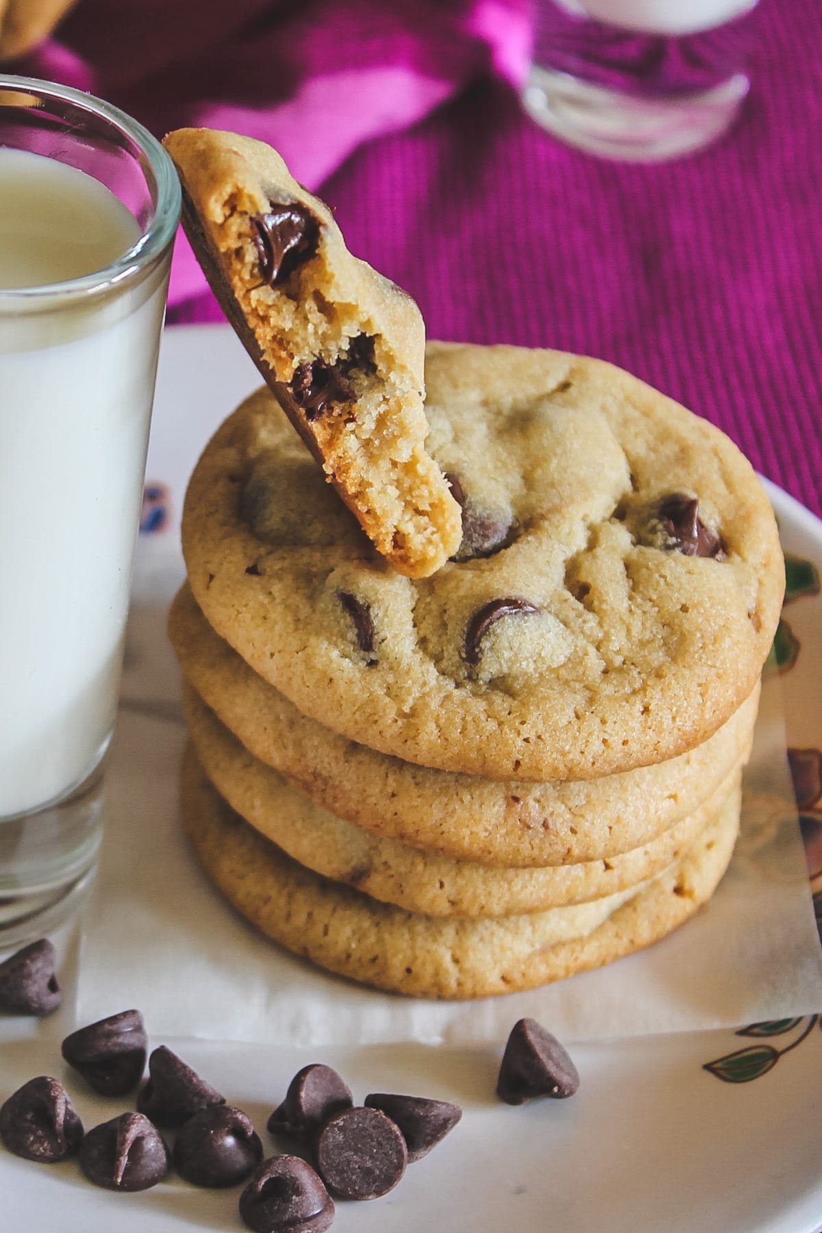 A stack of eggless cookies with one cookie has a bite taken.