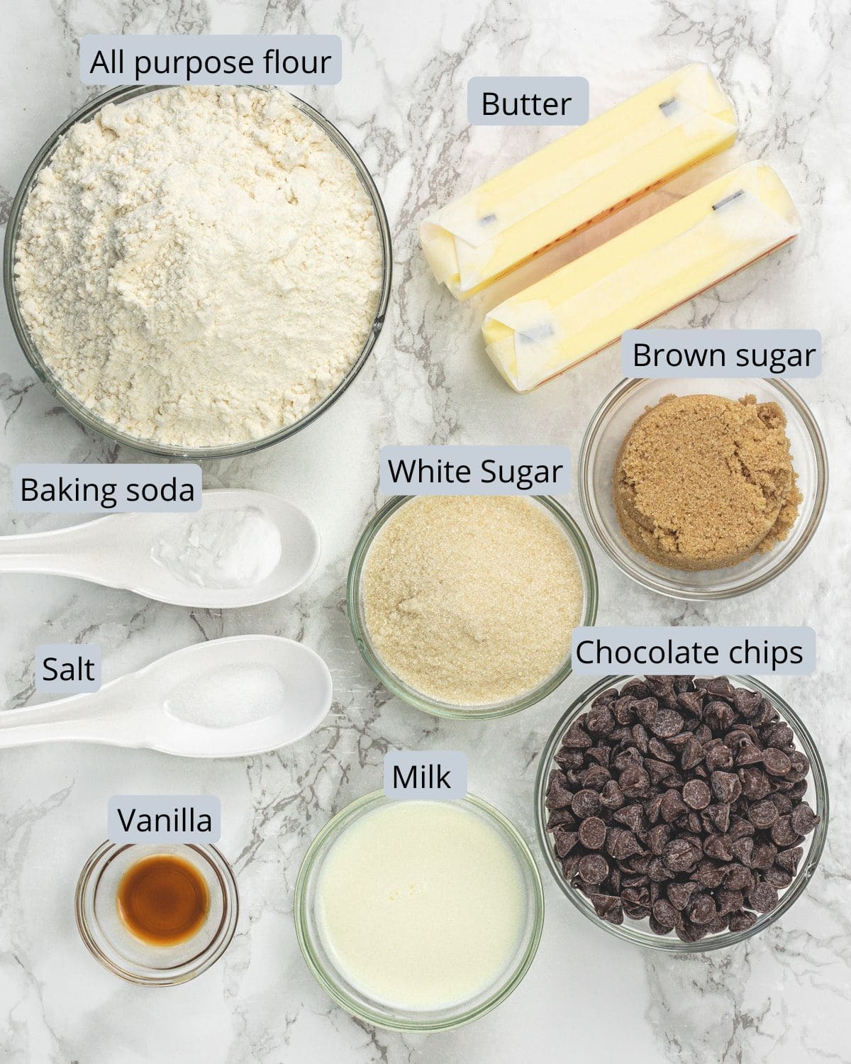 Eggless chocolate chip cookie recipe ingredients in bowls and spoons with labels.