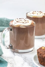 2 cups of hot chocolate with napkin on the side.