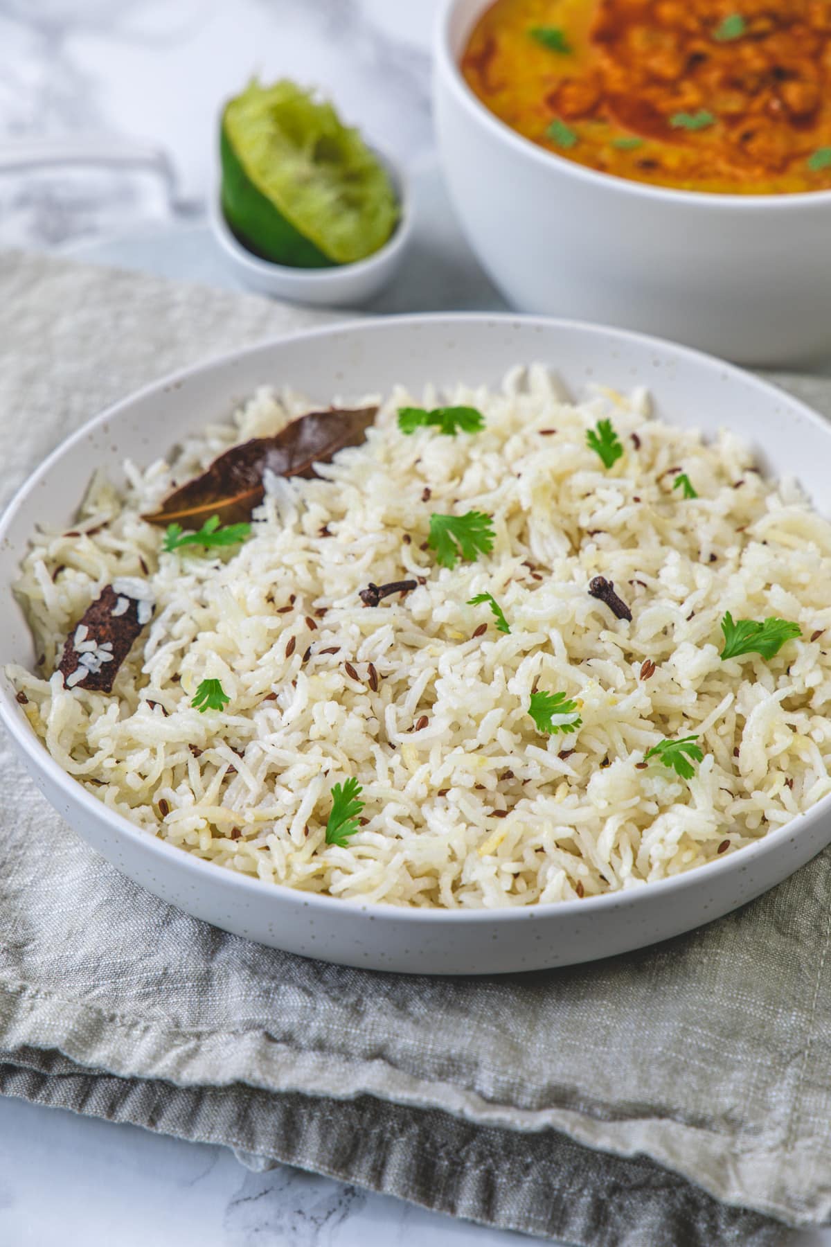 Jeera rice served in a plate with napkin under the plate.