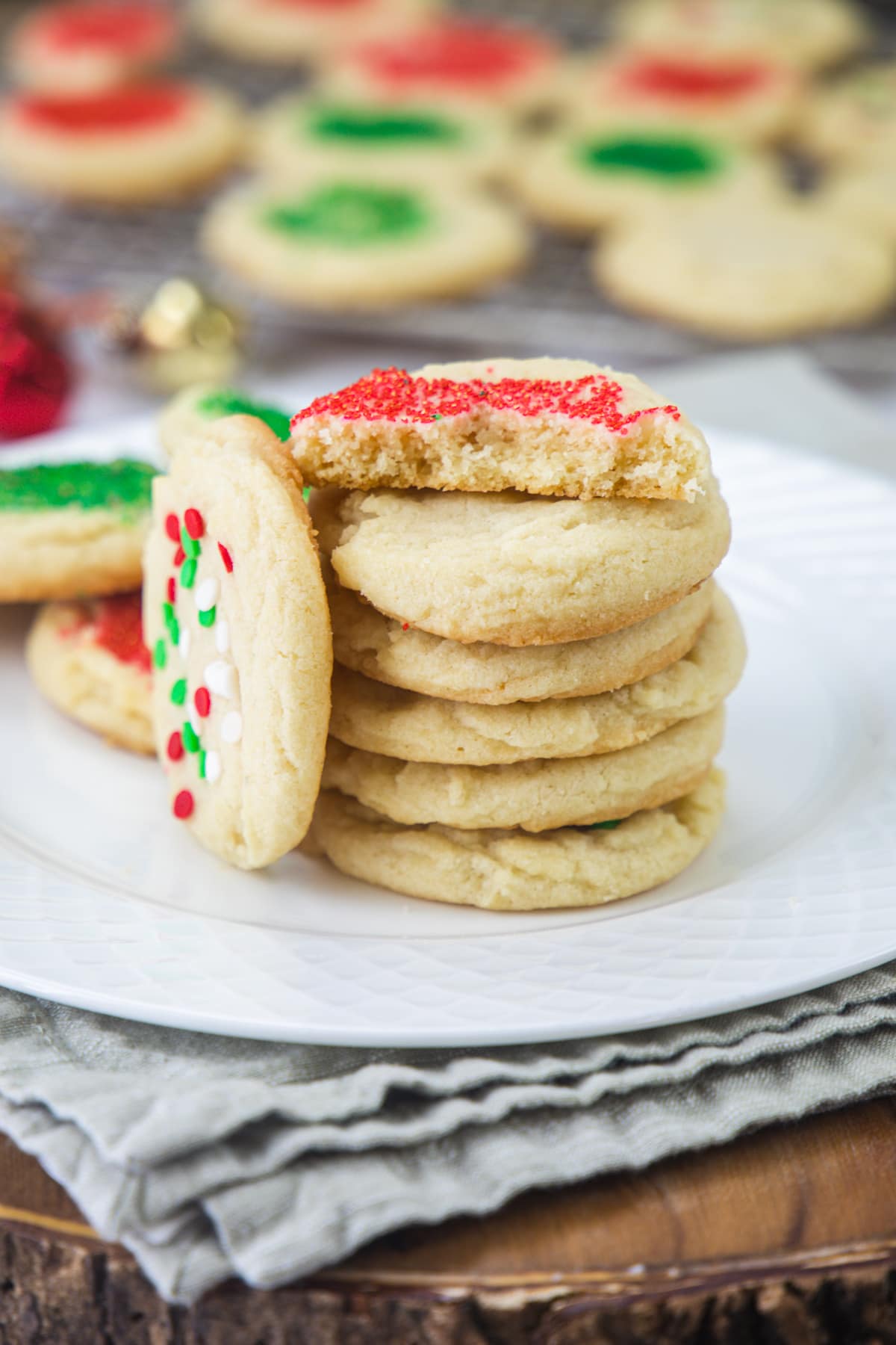 A stack of eggless sugar cookies with halved cookie on top.