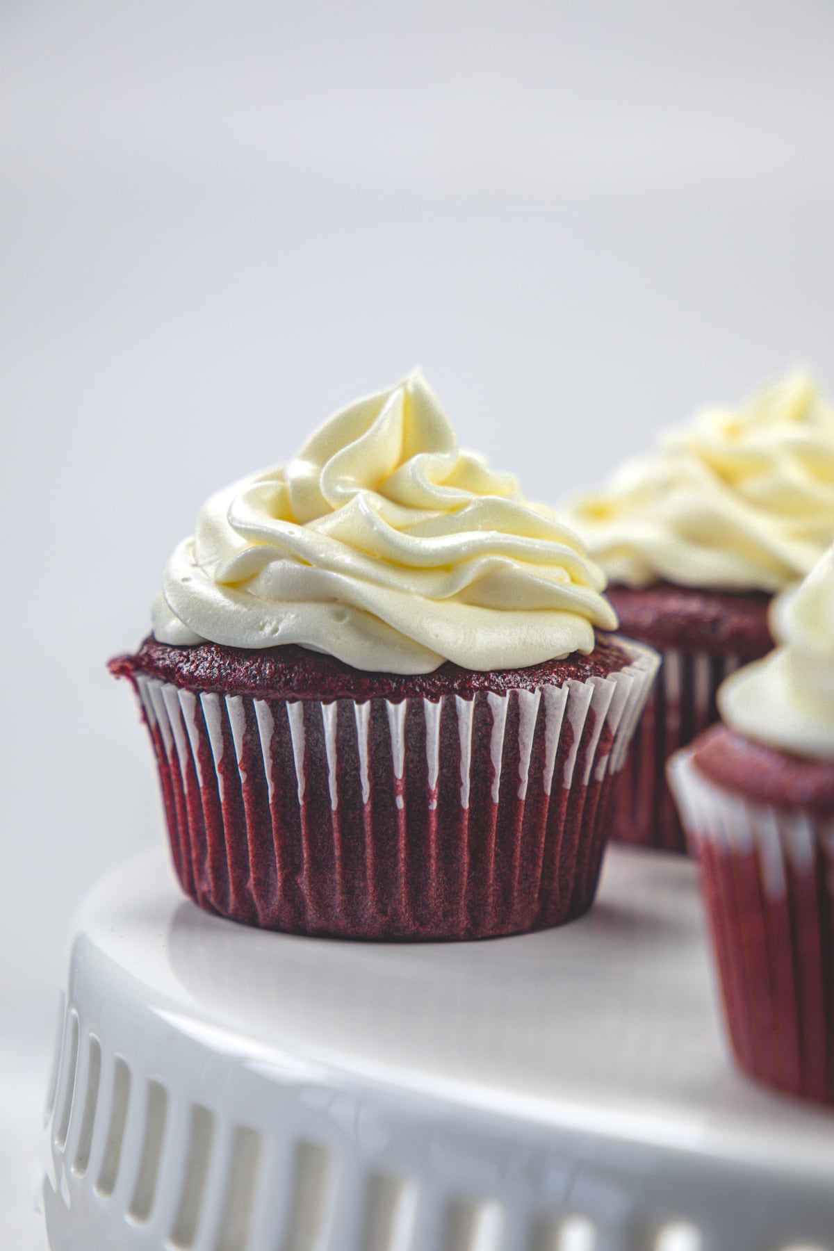 Eggless red velvet cupcake frosted with whipped cream cheese frosting.