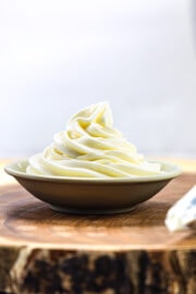 whipped cream cheese frosting piped in a small plate.