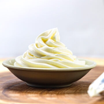 whipped cream cheese frosting piped in a small plate.