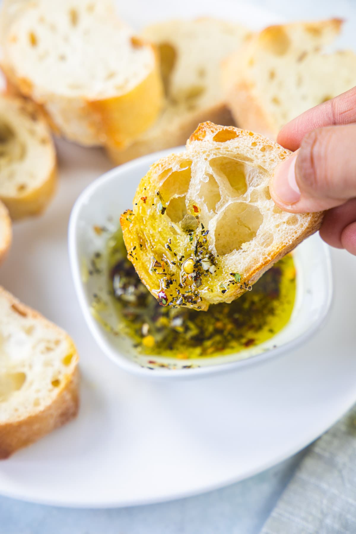 A bread slice dipped into bread dipping oil.