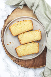 3 slices of eggless pound cake in a plate with napkin on the side.